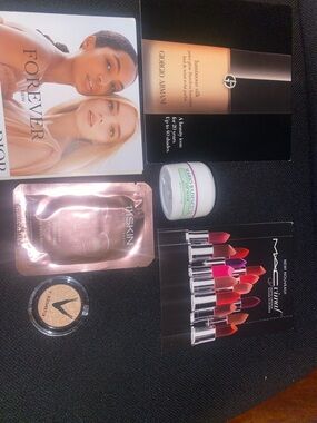 Assortment of cosmetics (MAC Cosmetics Lipstick Sample Card etc.)
